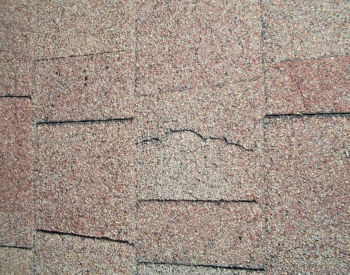 cracked roof shingles on a Burleson home.