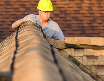 Inspecting a Sherman roof for summer damage